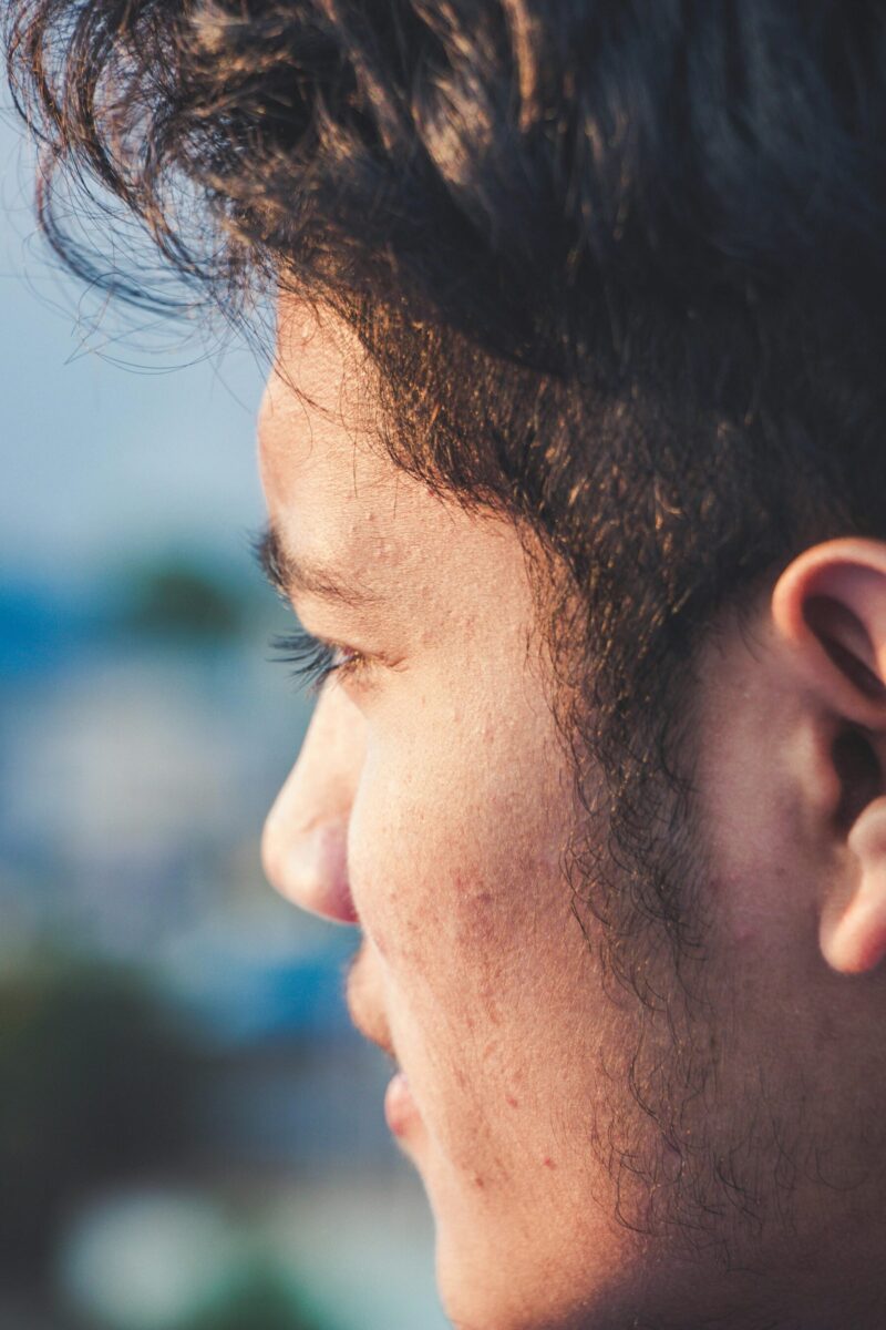 Close-up side profile of a man with overgrown sideburns, showing how sideburn length and balance affect a clean and polished look